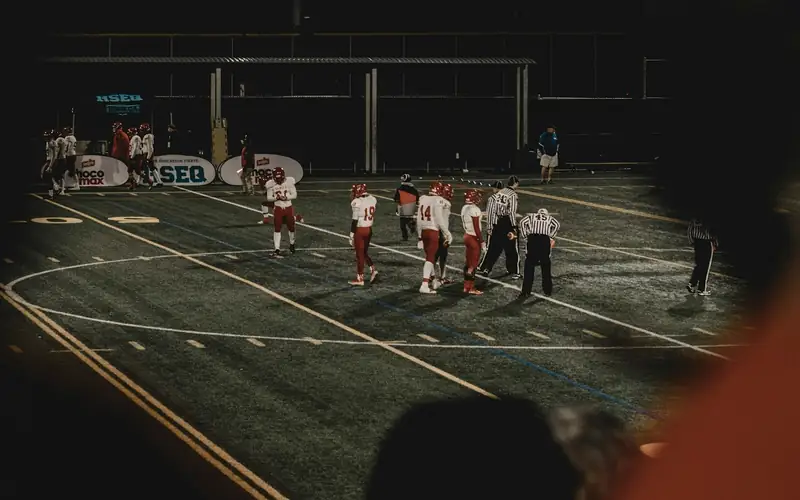 Floodlit stadium at night with players on the field, illustrating EM777PH sports betting